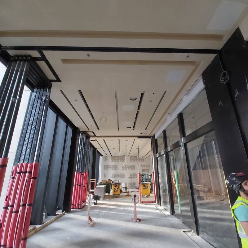 Commercial lobby with stepped plaster ceiling and recessed light slots