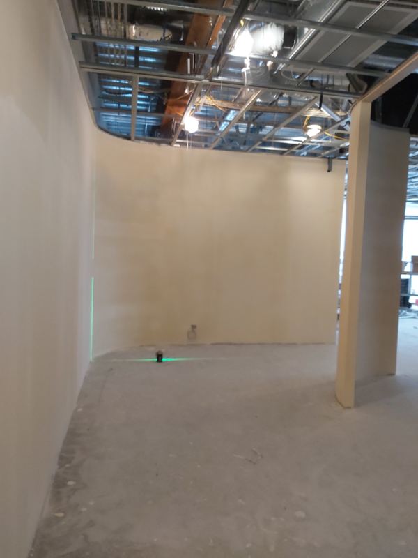 Smooth curved plaster wall set out with a laser level